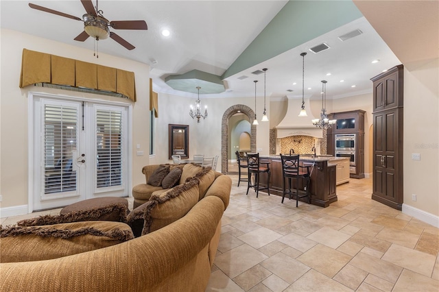 12860 Jacob Grace Ct, Windermere, FL 34786 - living area with a chandelier, a ceiling fan, arched walkways, baseboards, and crown molding