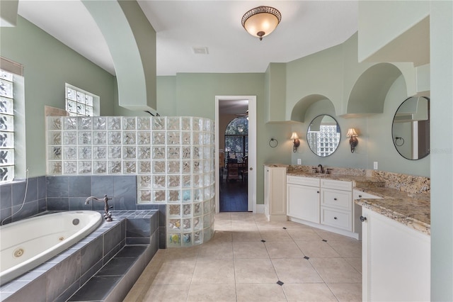 12860 Jacob Grace Ct, Windermere, FL 34786 - bathroom with vanity, a jetted tub, and tile patterned floors