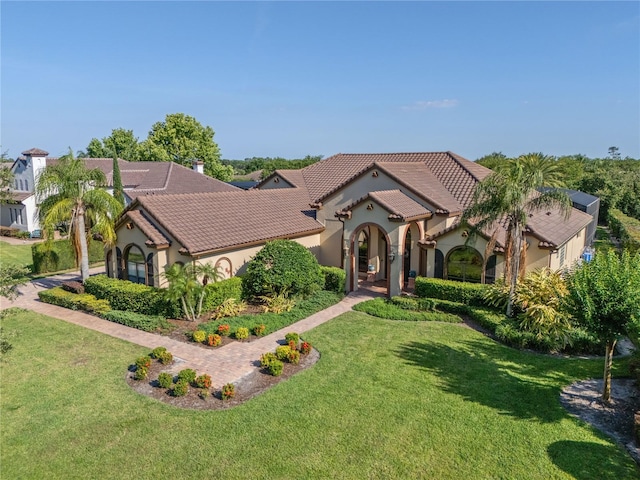 12860 Jacob Grace Ct, Windermere, FL 34786 - mediterranean / spanish home featuring stucco siding, a front yard, and a tiled roof
