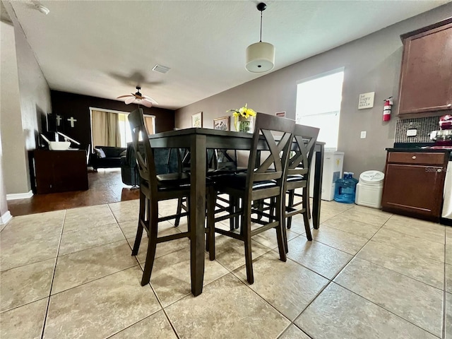 dining area with ceiling fan, light tile patterned floors, visible vents, and baseboards