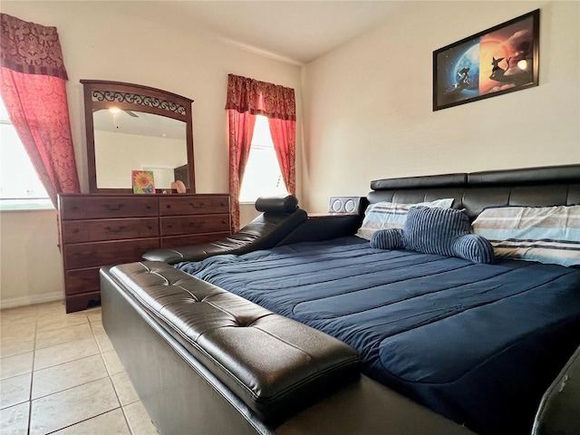 bedroom featuring baseboards and light tile patterned floors