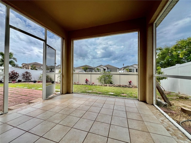 unfurnished sunroom featuring a residential view