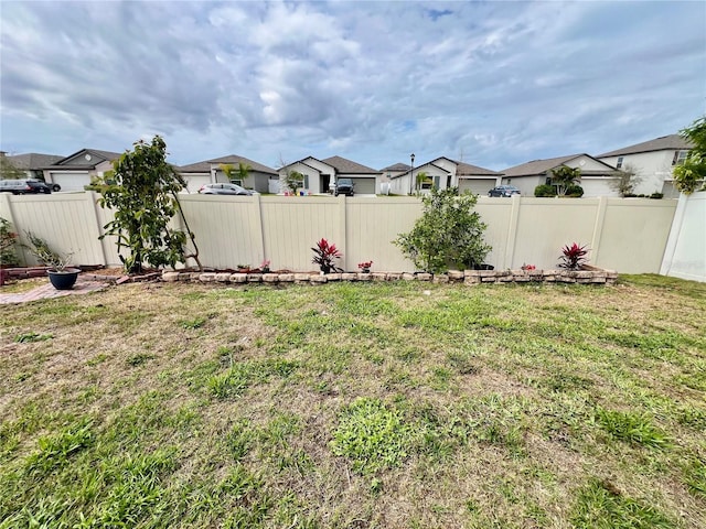 view of yard with a residential view and a fenced backyard