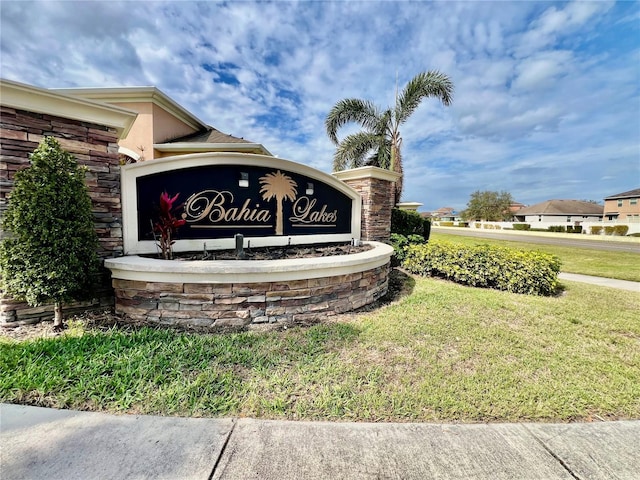 community sign featuring a lawn