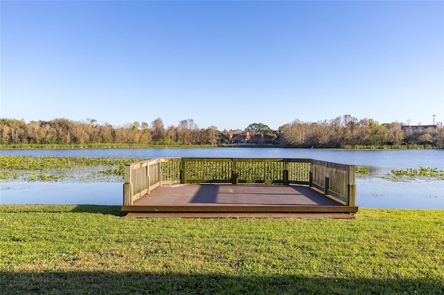 view of dock featuring a deck with water view and a yard