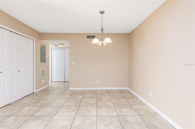 spare room featuring electric panel, visible vents, a chandelier, and light tile patterned flooring