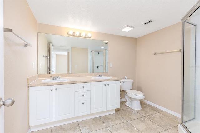 bathroom featuring toilet, a sink, visible vents, and a shower stall