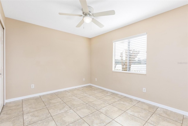 empty room featuring a ceiling fan, baseboards, and light tile patterned floors