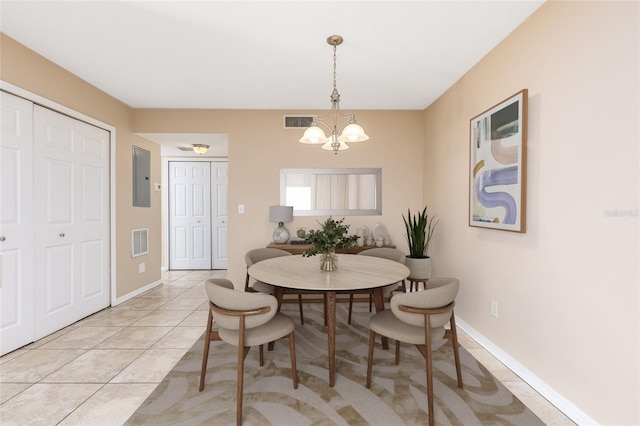 dining space with light tile patterned flooring, electric panel, an inviting chandelier, and visible vents