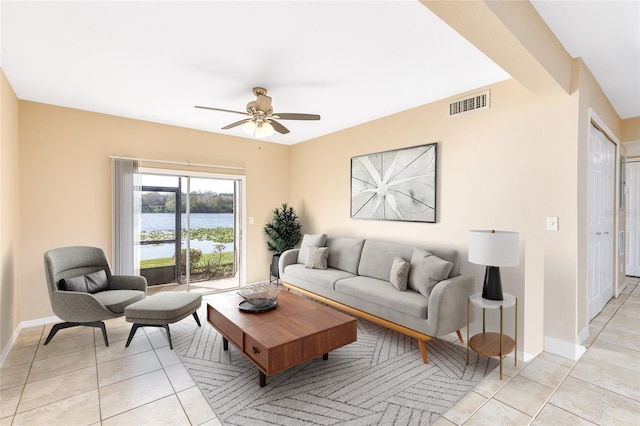 living area with light tile patterned floors, visible vents, and ceiling fan