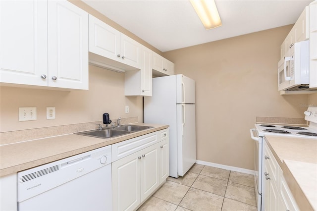 kitchen featuring white appliances, white cabinetry, light countertops, a sink, and baseboards