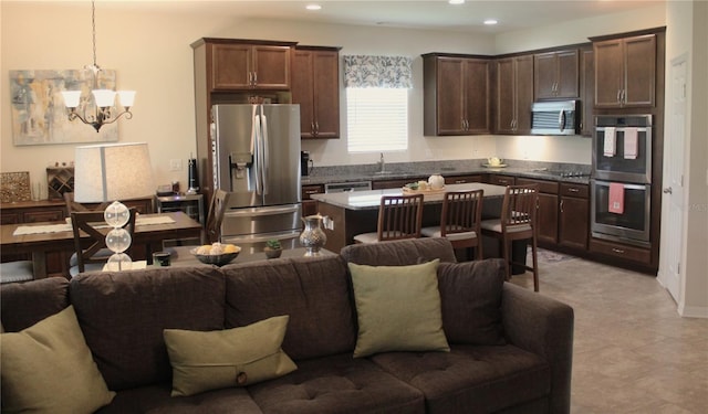 4110 Arlington Ridge Blvd, Leesburg, FL 34748 - kitchen featuring open floor plan, appliances with stainless steel finishes, dark brown cabinets, a chandelier, and recessed lighting