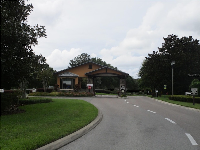4110 Arlington Ridge Blvd, Leesburg, FL 34748 - view of asphalt street with street lighting, curbs, and traffic signs