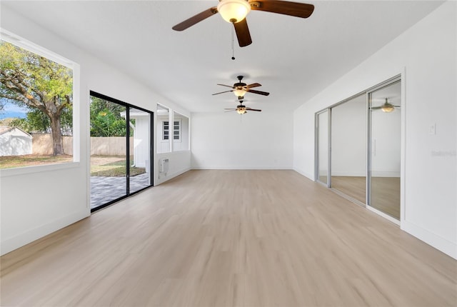 interior space featuring light wood-type flooring and baseboards