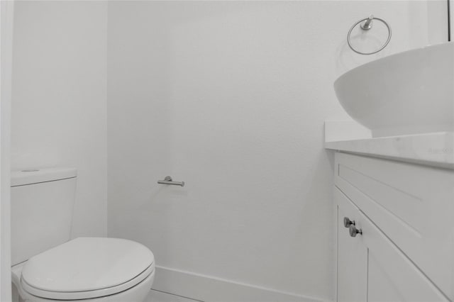 bathroom featuring toilet and vanity