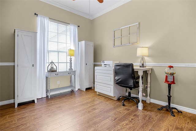 office area featuring ornamental molding, a ceiling fan, baseboards, and wood finished floors