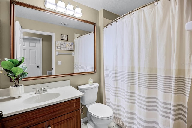 bathroom with toilet, visible vents, a textured ceiling, and vanity