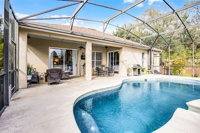 exterior space with a patio, a ceiling fan, roof with shingles, an outdoor pool, and stucco siding