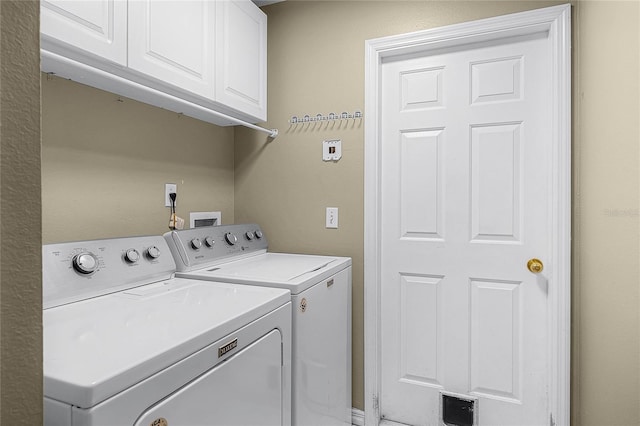 washroom with cabinet space and independent washer and dryer