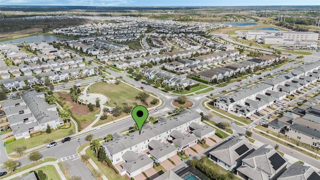 drone / aerial view featuring a water view and a residential view