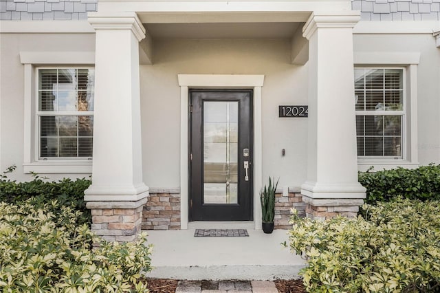 view of exterior entry featuring stone siding