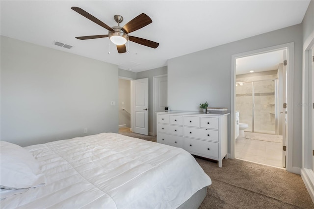 carpeted bedroom featuring visible vents, a ceiling fan, and ensuite bathroom