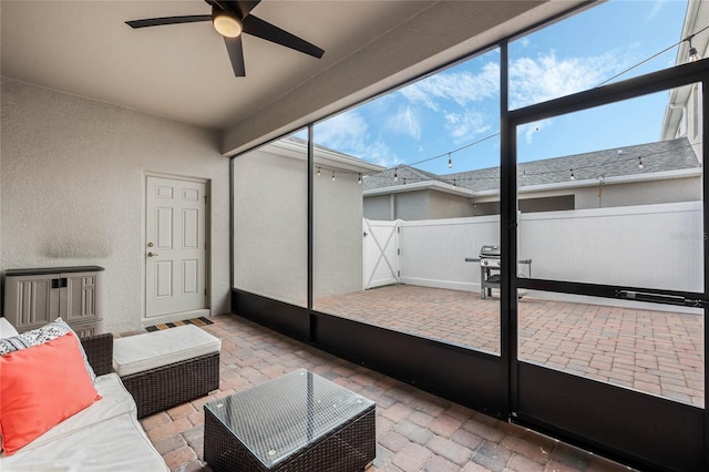 sunroom / solarium featuring ceiling fan