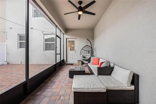 sunroom / solarium with a ceiling fan