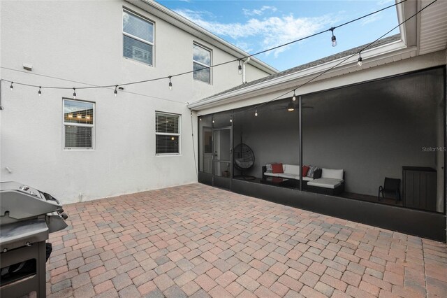 view of patio / terrace with a grill and a sunroom