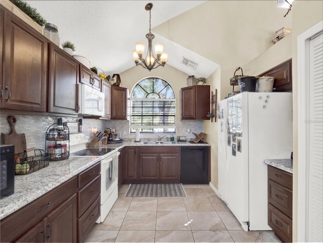 kitchen with lofted ceiling, visible vents, a sink, a chandelier, and white appliances