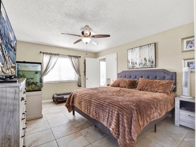 bedroom with a textured ceiling and a ceiling fan