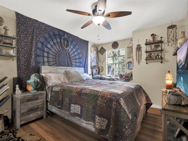 bedroom with baseboards, a textured ceiling, a ceiling fan, and wood finished floors