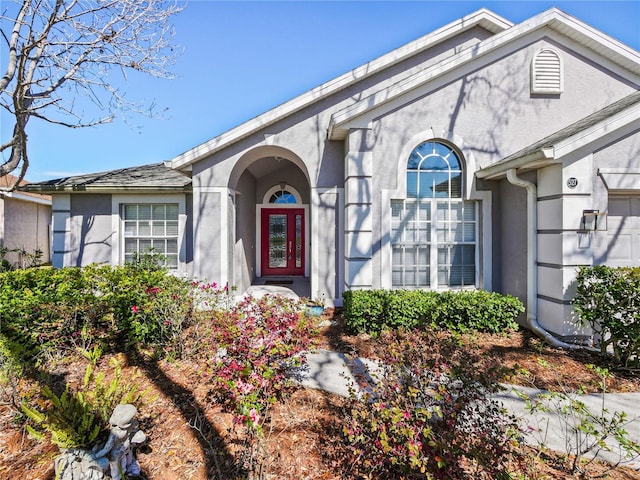 view of exterior entry featuring stucco siding