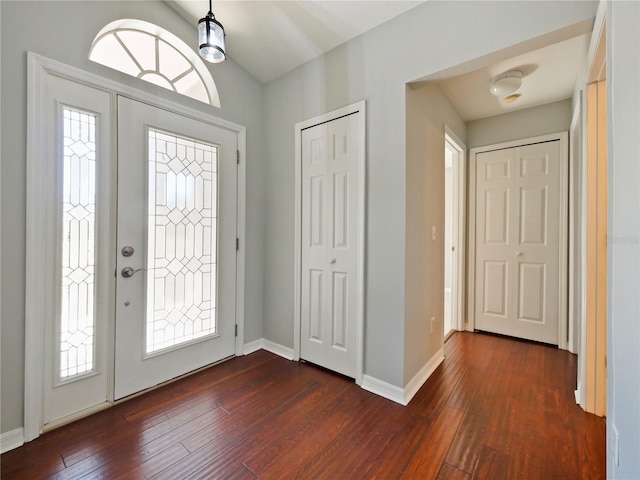 foyer featuring dark wood-type flooring and baseboards