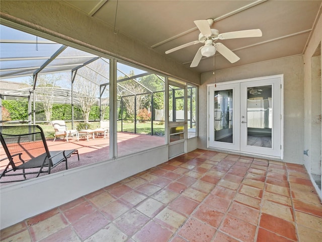 unfurnished sunroom with a ceiling fan