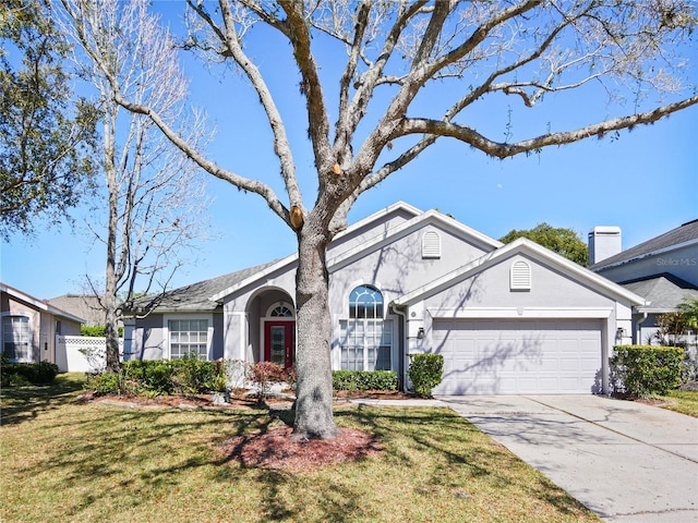 view of front of home featuring an attached garage, fence, concrete driveway, and stucco siding