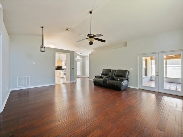 unfurnished living room featuring vaulted ceiling, french doors, dark wood finished floors, and visible vents