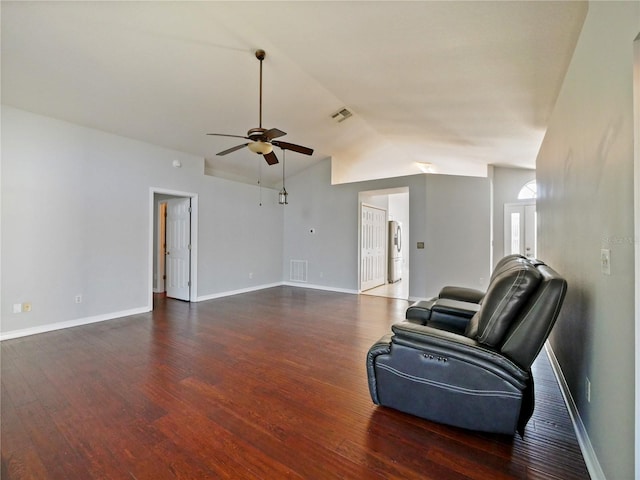 sitting room with lofted ceiling, wood finished floors, visible vents, and a ceiling fan