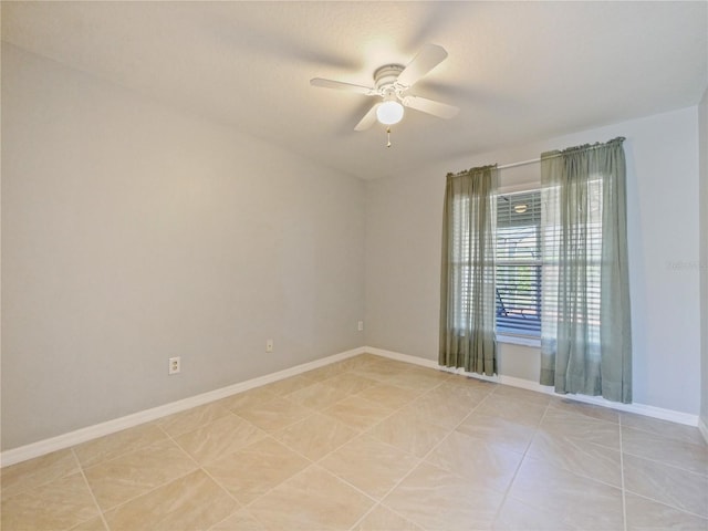 unfurnished room featuring ceiling fan, baseboards, and light tile patterned floors