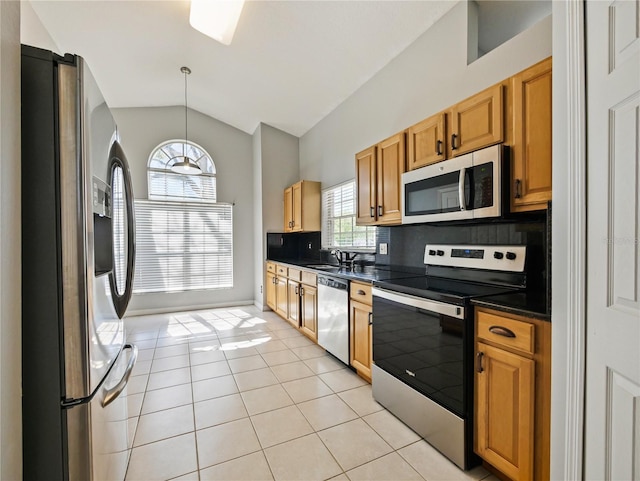 kitchen featuring lofted ceiling, light tile patterned floors, stainless steel appliances, backsplash, and dark countertops