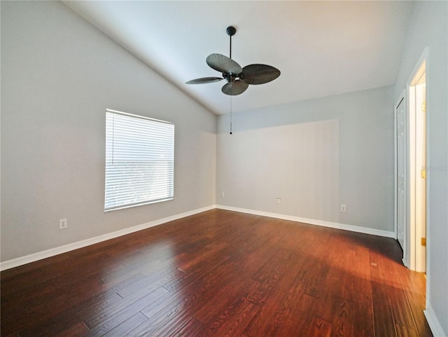 spare room with lofted ceiling, ceiling fan, wood finished floors, and baseboards