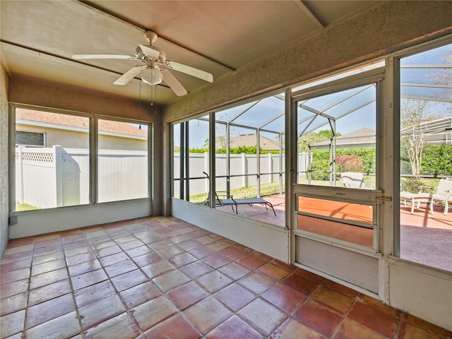 unfurnished sunroom featuring ceiling fan