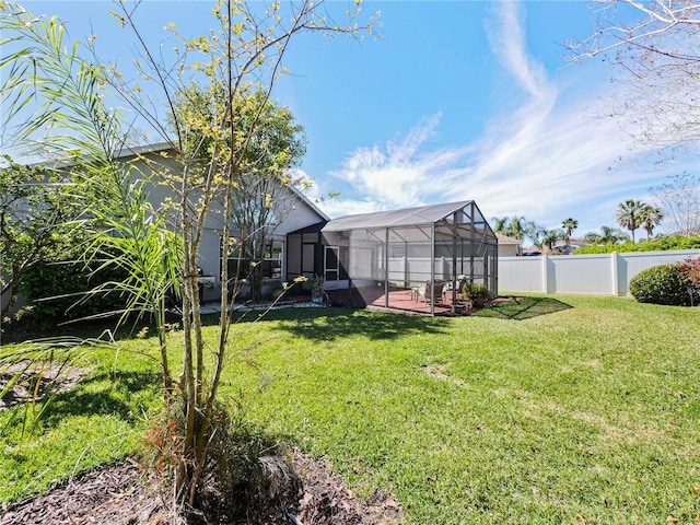 view of yard with glass enclosure and a fenced backyard