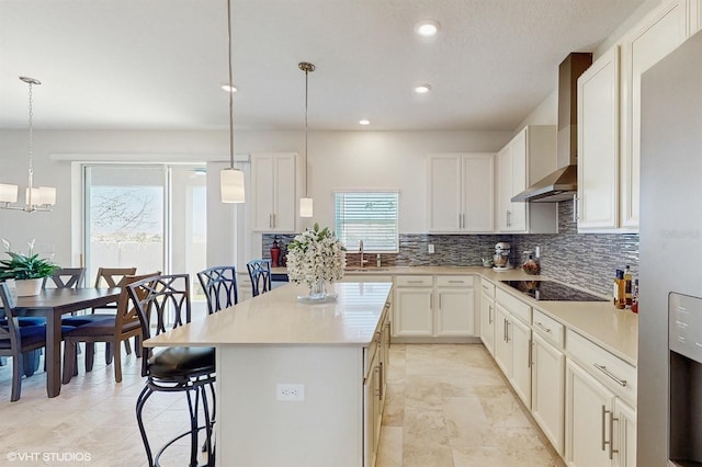 kitchen with a center island, a sink, backsplash, and a kitchen breakfast bar