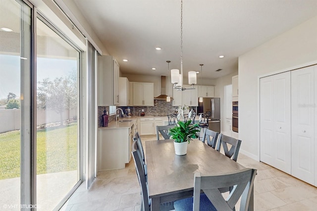 dining area featuring baseboards and recessed lighting