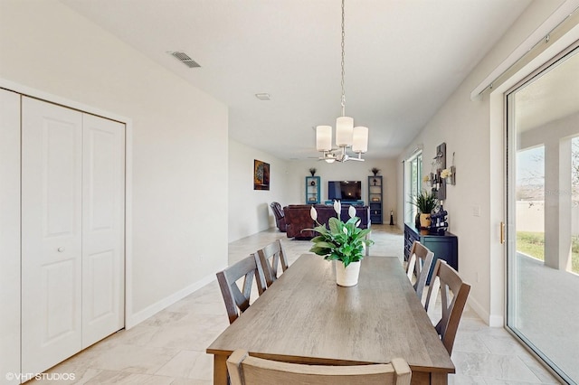 dining area with marble finish floor, plenty of natural light, and visible vents