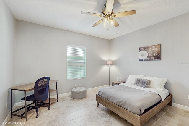 bedroom with ceiling fan, marble finish floor, and baseboards