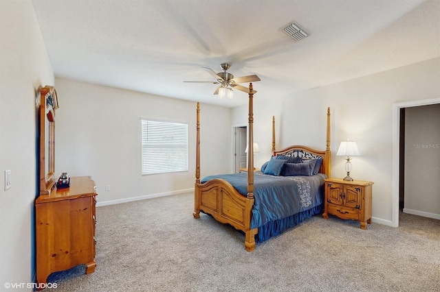 bedroom featuring a ceiling fan, visible vents, light carpet, and baseboards