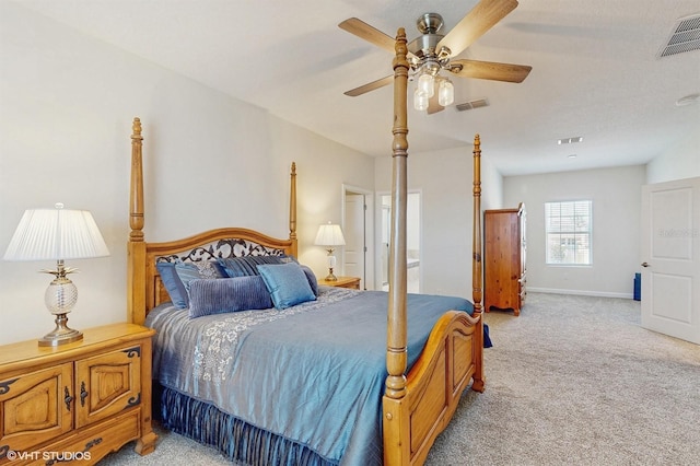 bedroom with baseboards, visible vents, a ceiling fan, and light colored carpet