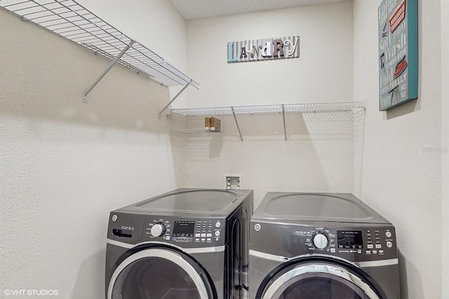 laundry area with laundry area and washer and clothes dryer